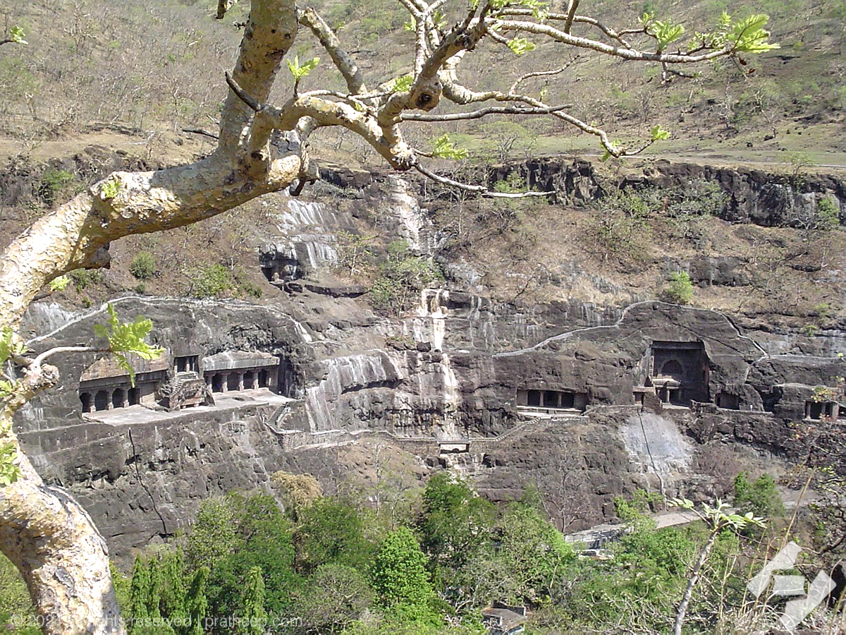 Ajanta cliff face into which the caves are excavated . View from across Waghora riverbank.