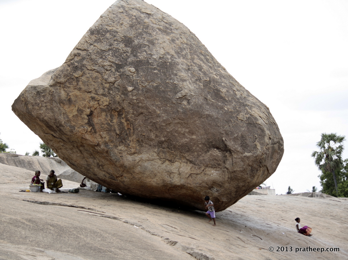 Precariously balancing boulder. There is a makeshift enterprise working under it! 