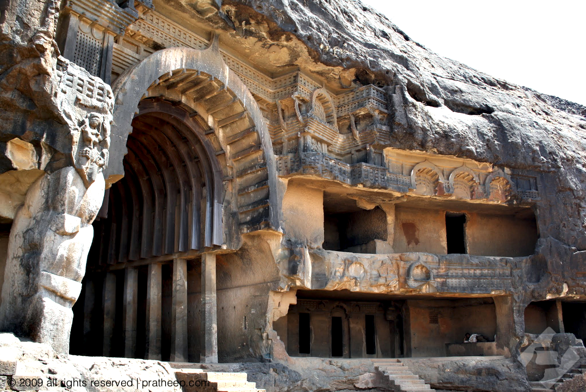 This is the main prayer hall at Bhaja Caves. The chaitya was originally faced by a substantial wooden facade, which been lost over time. On the sides are the living quarters of the monks, spanning over multiple tires.
The whole structure, including the pillars and artistic work is scooped out of the rocky cliff. 