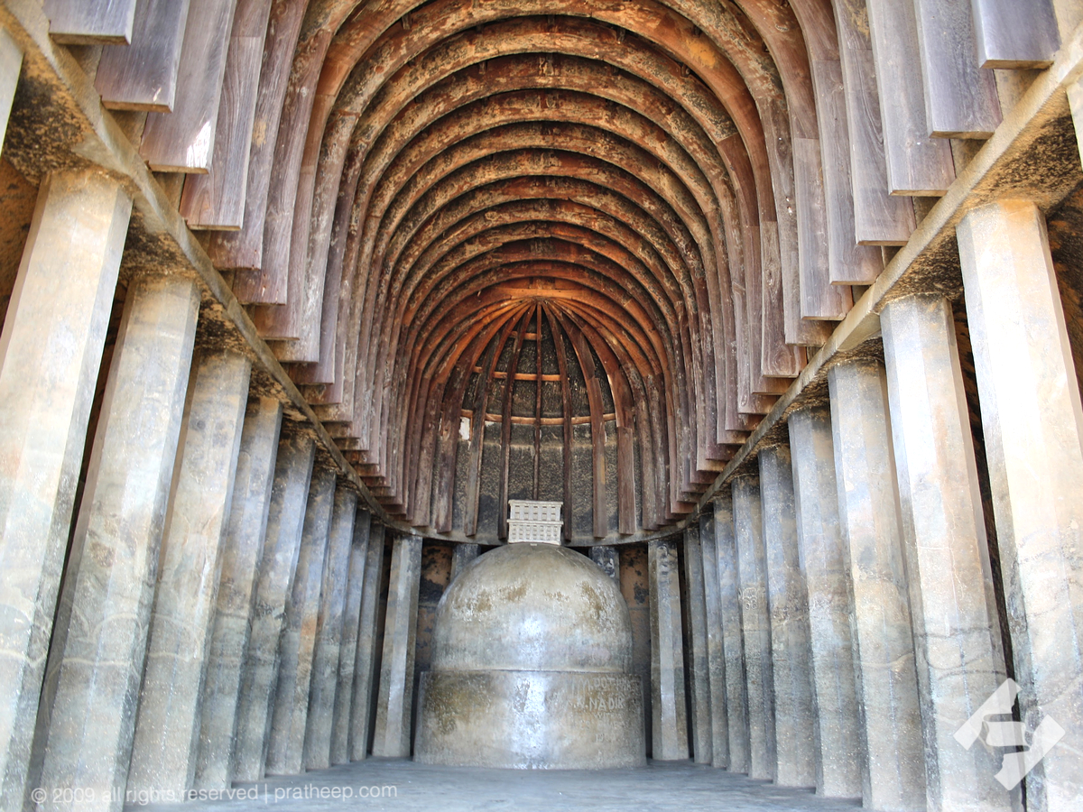 Dating back from second century BCE, one of the earliest surviving chaitya halls in India.
The octagonal columns on either side (27 numbers) tapers towards the top, imitating wooden columns design, but all are carved out in situ.
Wooden ribs on the barrel-vaulted ceiling are new wooden replicas. The original wooden structures could have lost with time. However the ceiling has slots & sockets for the wooden structures , giving the hint of original design.
The chaitya is 26 feet 8 inches wide and 59 feet long. The dagoba (stupa) has a diameter of 11 feet at the floor. 